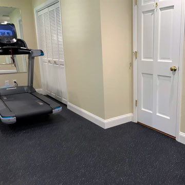Soft rubber flooring for use over hard wood flooring