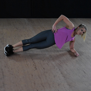 doing side planks on a calisthenic exercise mat