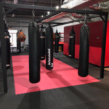 Boxing workouts in gym with foam mat floors