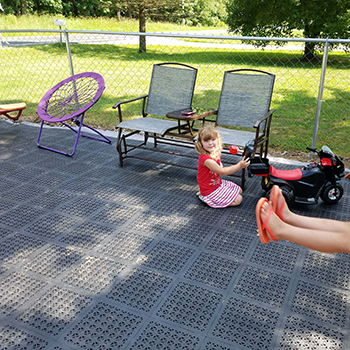 deck tiles installed on grass with kids