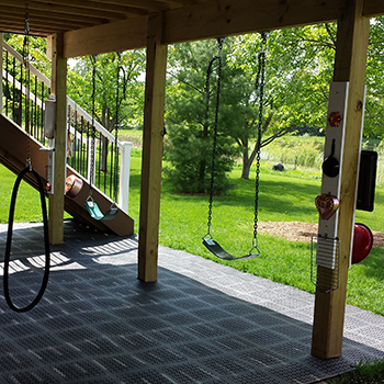 plastic outdoor deck tile installed over grass