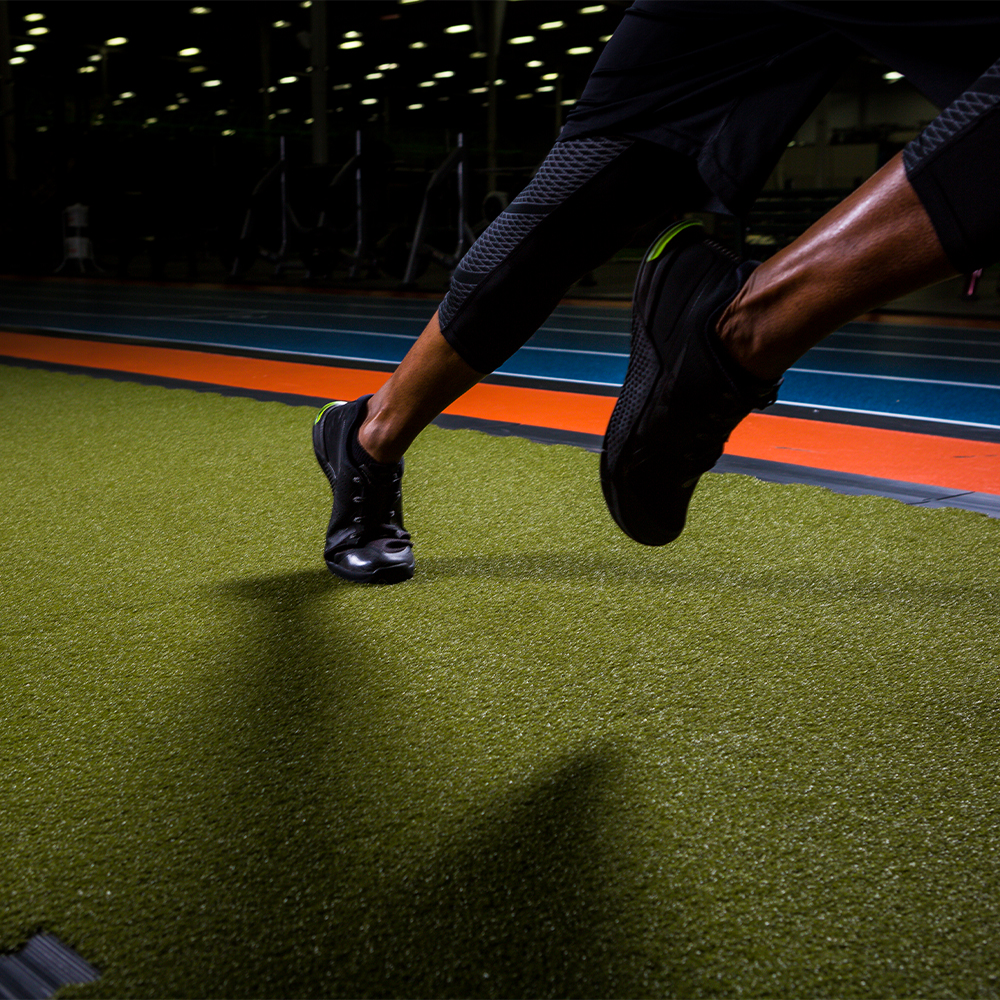 athlete running on turf