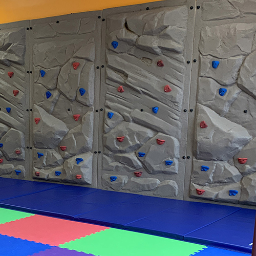 Folding crash pad mat at the bottom of a Climbing wall