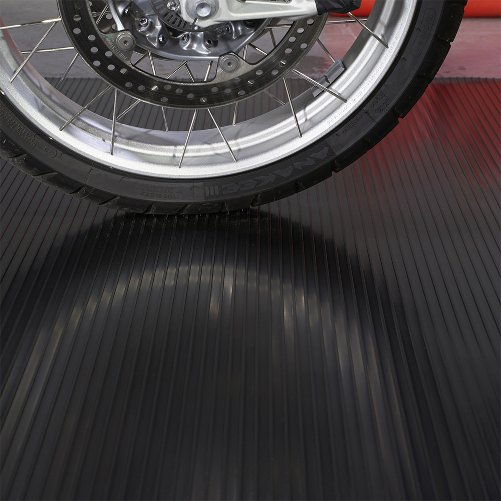 Motorcycle park on G-Floor Ribbed Tread Vinyl Multipurpose Roll 1.4 mm x 5x10 Ft. in midnight black