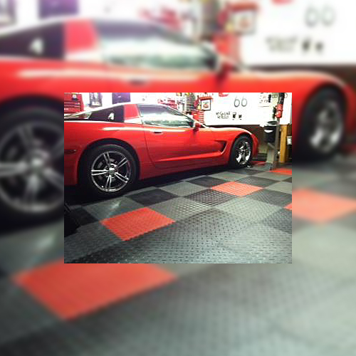 Diamond Plate Garage Floor Tiles with Red Car Parked On It