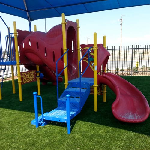 playground with artificial turf and shade canopy