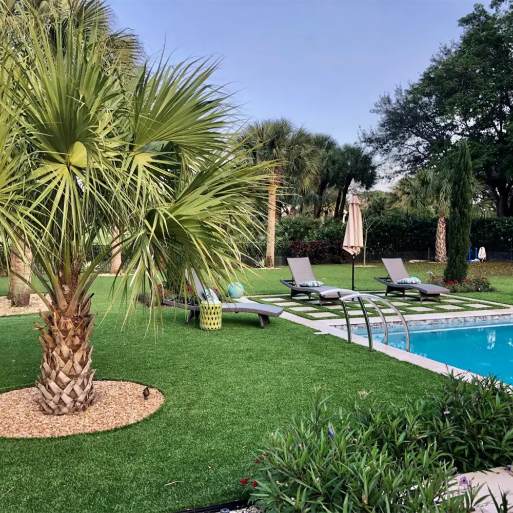 artificial grass used poolside in yard with pool