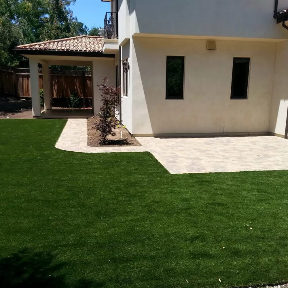 back yard of home with artificial grass turf