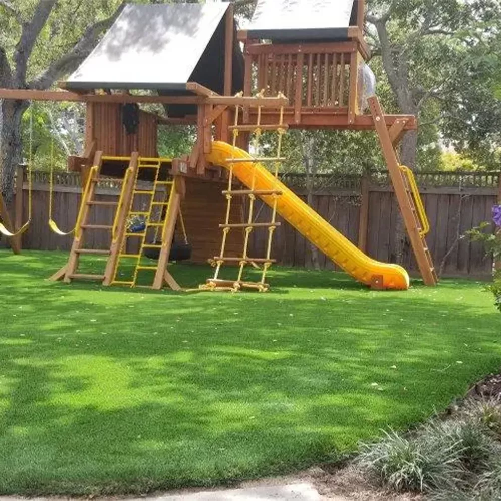 playground turf and playground equipment in shade under trees