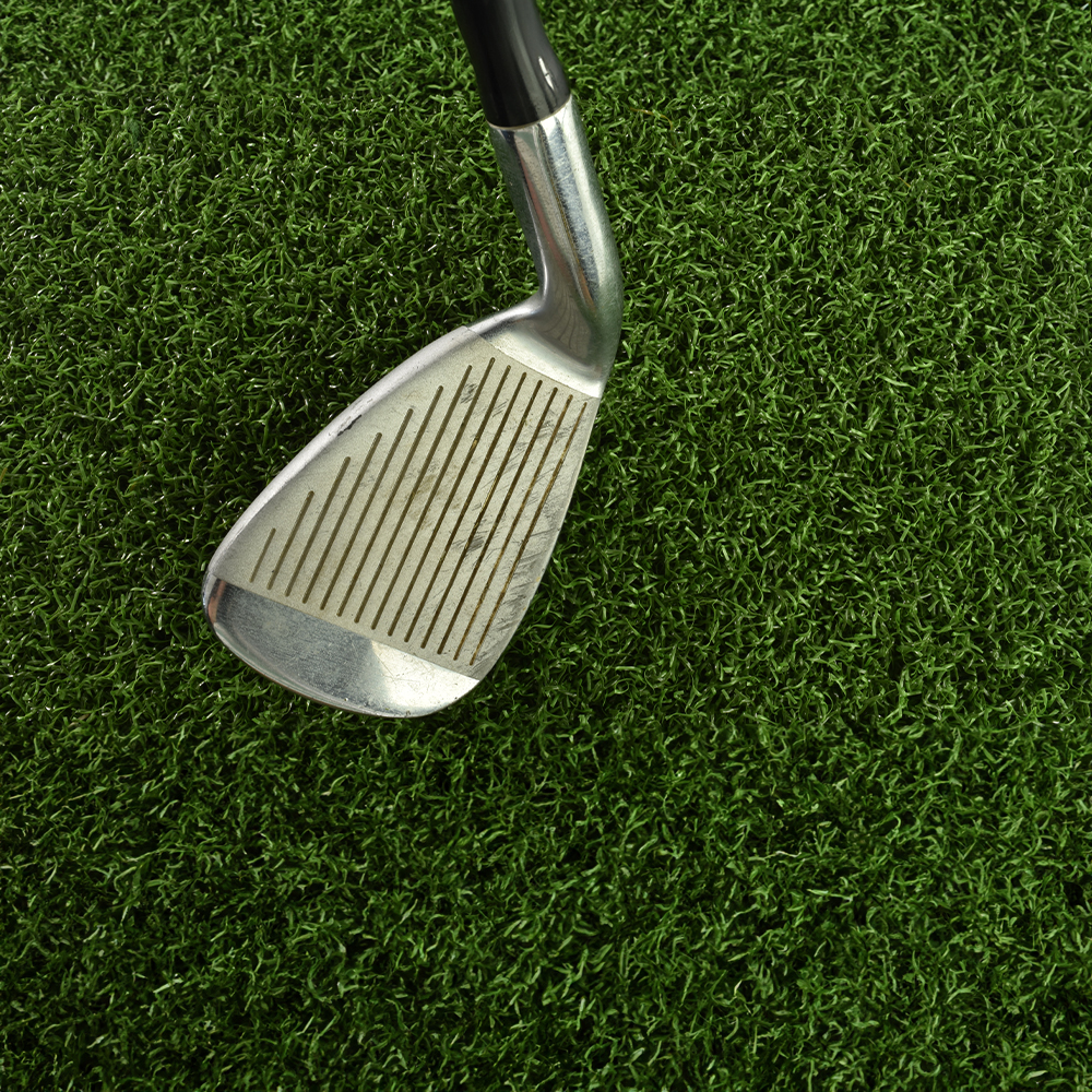 Troon Artificial Turf Roll with 7 iron golf club close up