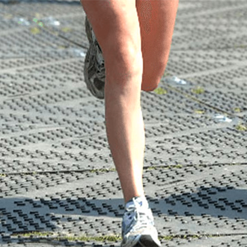 person running on liberty ground protection mats