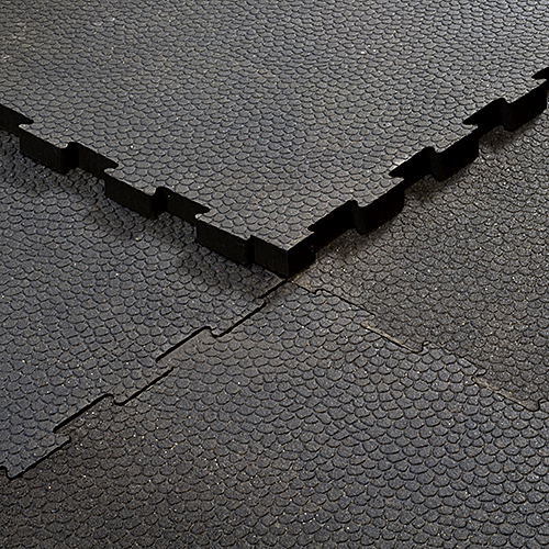 close up of 4 interlocking horse stall mats connected together