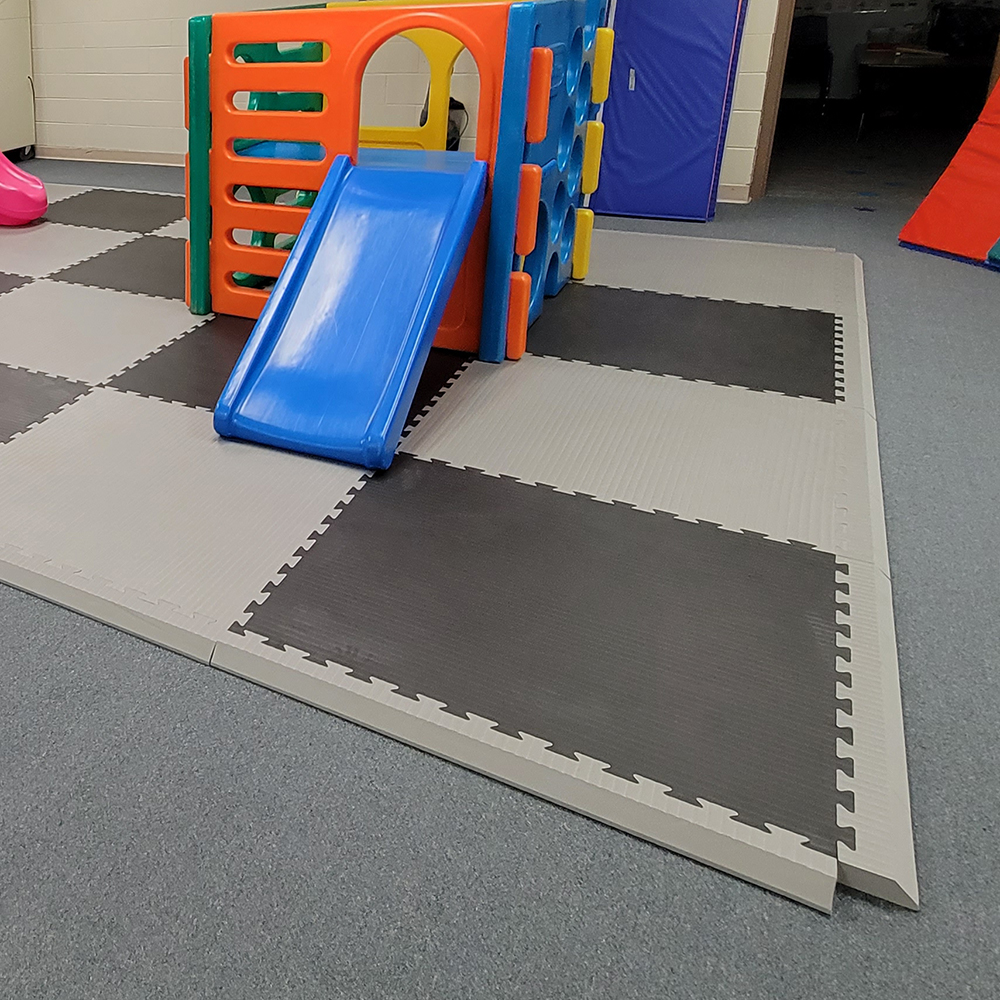 indoor playground flooring tiles with gray ramped border edges