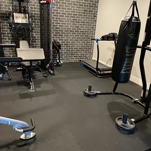 interlocking rubber tiles used in home gym with equipment on top