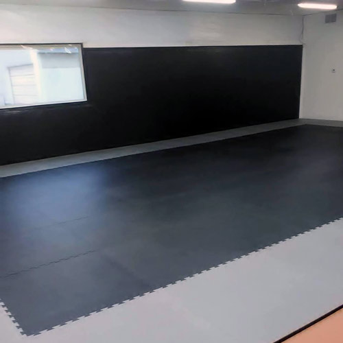 Puzzle mats for protective flooring to practice front and back flips
