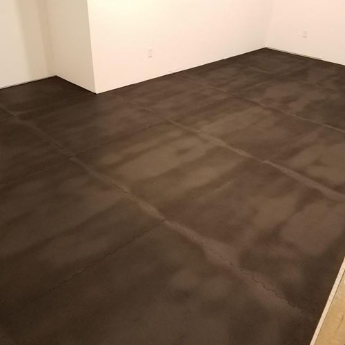 Rubber gym mats on hardwood flooring