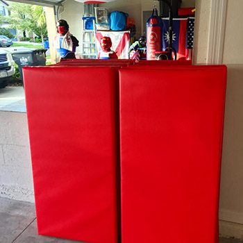Red folding mats in garage dojo