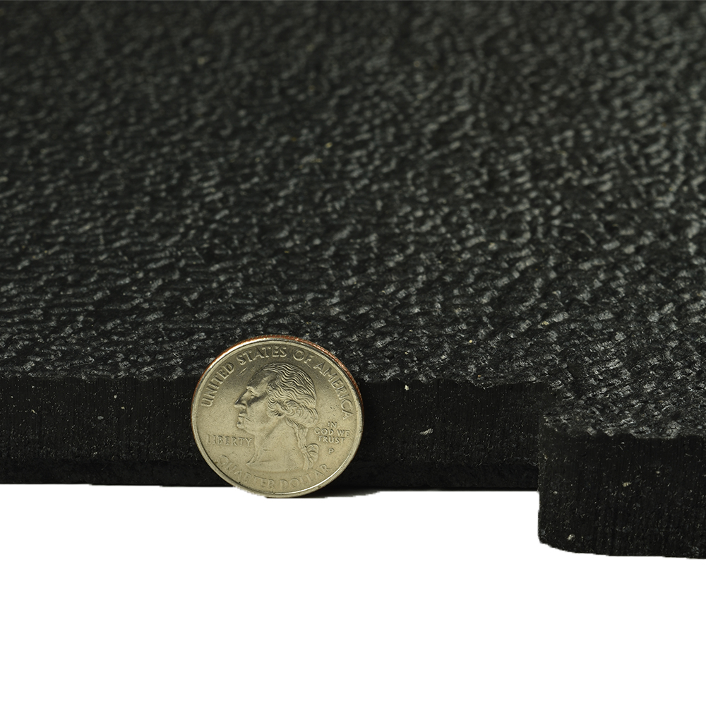 rubber horse stall mat showing 3/4 inch thickness with quarter