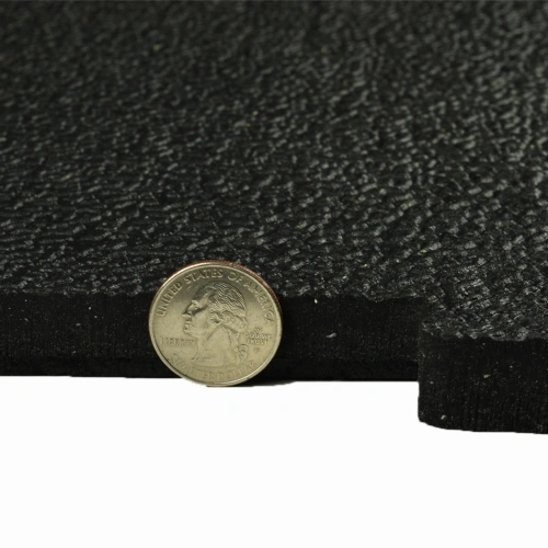 rubber horse stall mat showing 3/4 inch thickness with quarter