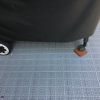 grey patio outdoor tiles on deck underneath grill