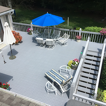 light gray pvc outdoor deck tiles installed over existing wood deck
