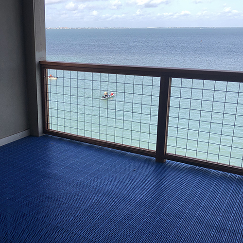 blue interlocking Patio Outdoor Tiles installed on a balcony
