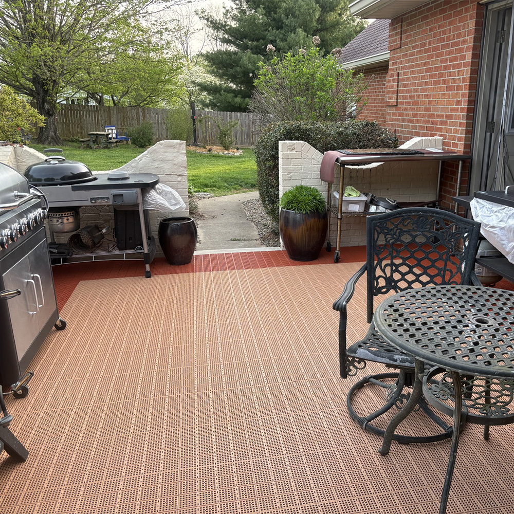 tan and terra cotta interlocking Patio Outdoor Tiles installed in patio with grills