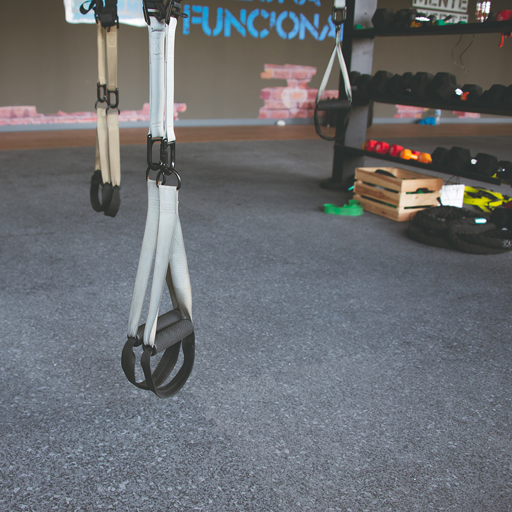 gray and black speckled rubber gym tiles installed in commercial fitness studio