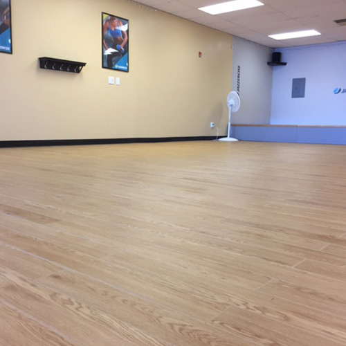 Raised woodgrain plank flooring for indoor court flooring