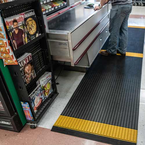 Worker Standing on Social Distance Floor Mats