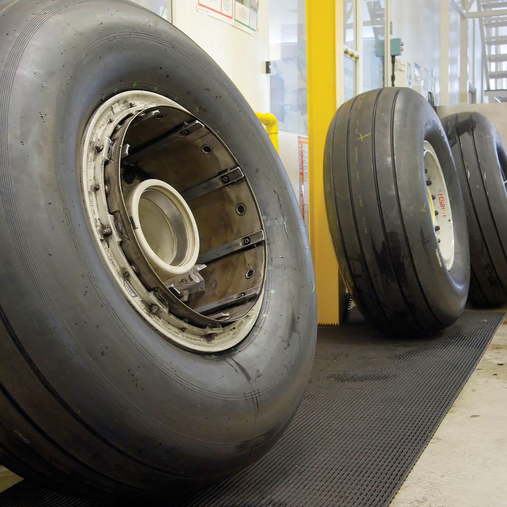 large tires sitting on Firmagrip Matting in mechanic shop