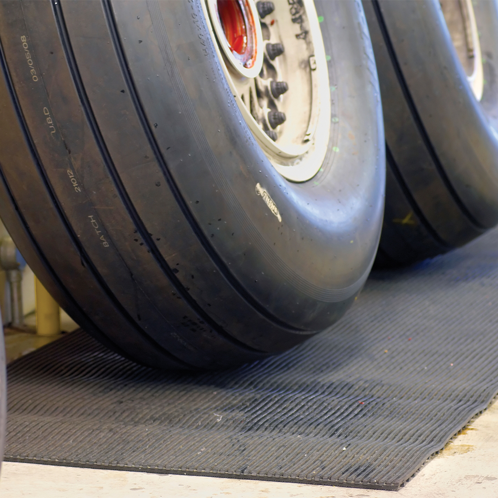 large tires sitting on Firmagrip Matting in mechanic shop