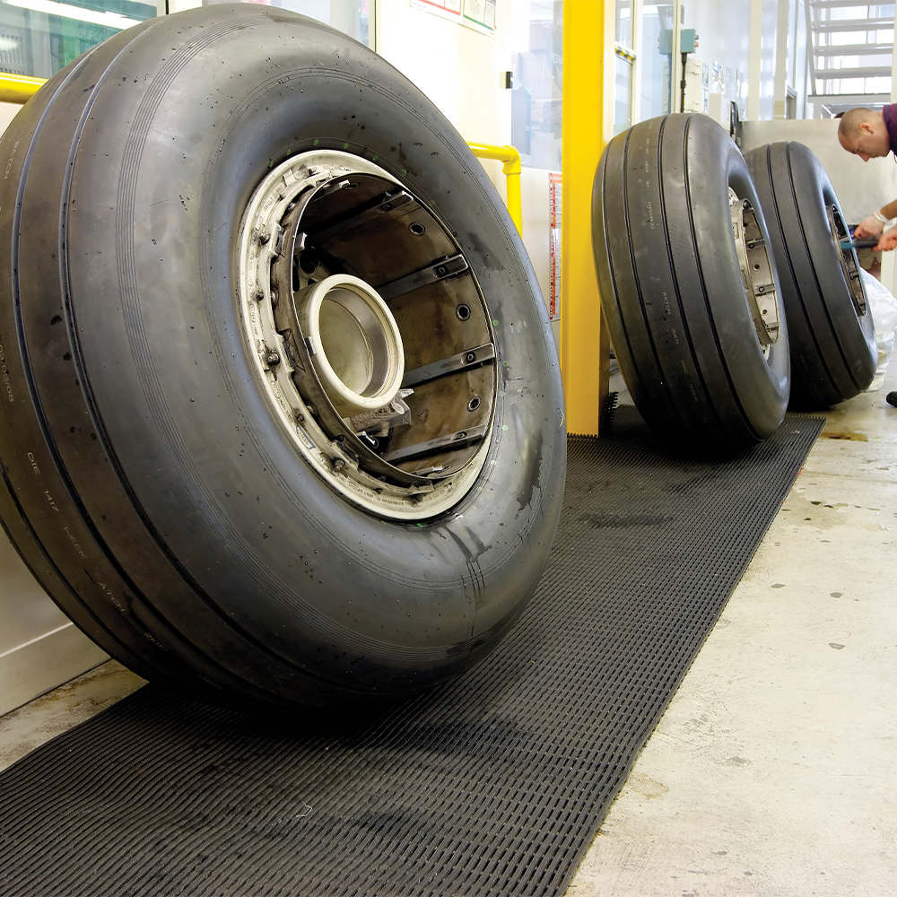 large tires sitting on Firmagrip Matting in mechanic shop