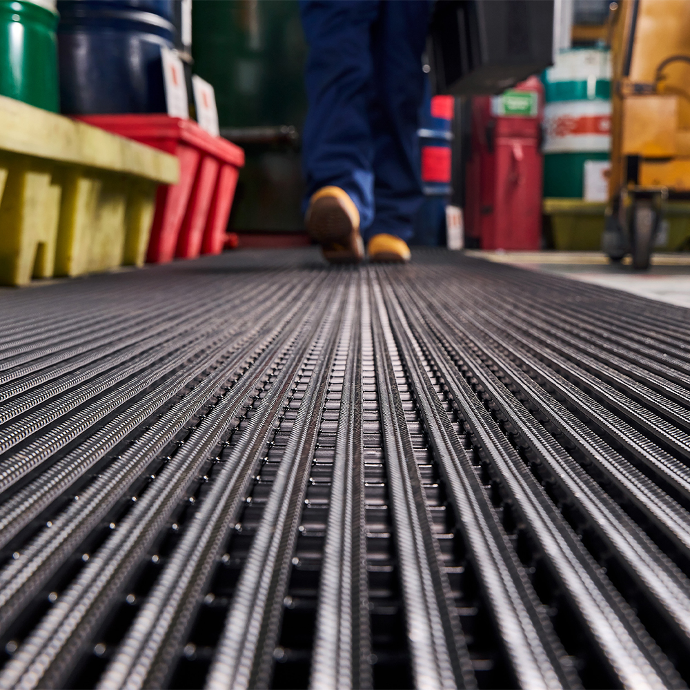 person walking on Flexigrid Industrial Matting 3 x 16.5 ft Roll 