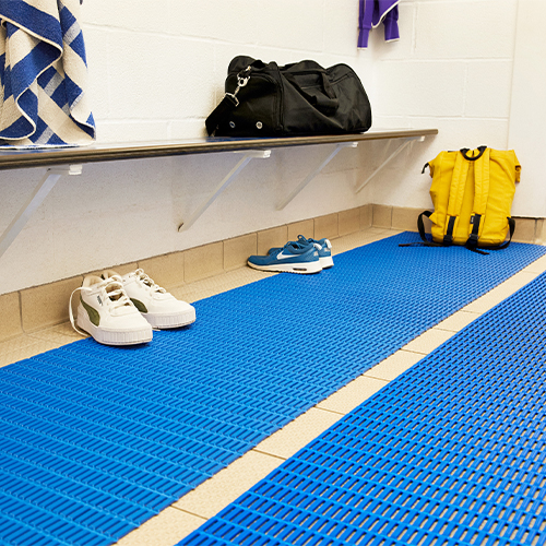 blue floor mats in locker room with bench