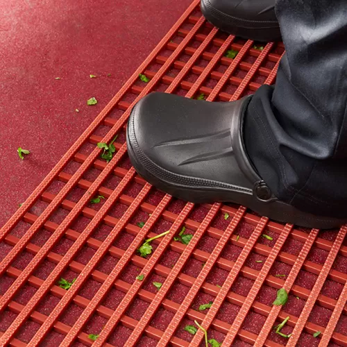 standing on red anti slip drainage matting