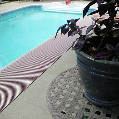 gray heronrib wet area matting alongside inground pool