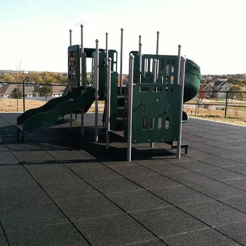 Playground flooring rubber tiles installation in a neighborhood.