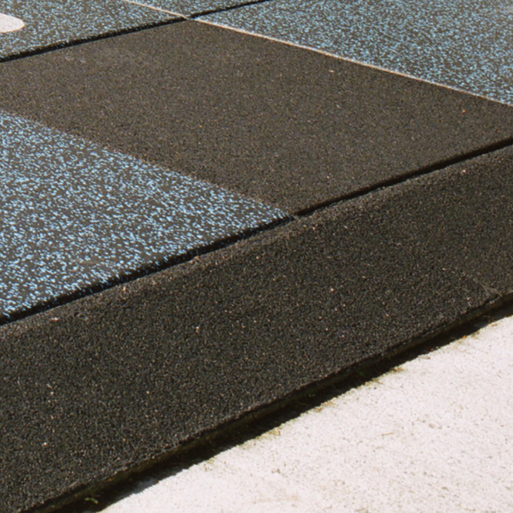 rubber border ramp installed with black and blue playground tiles
