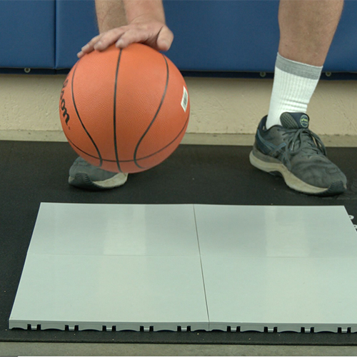 plastic basketball court tiles over top of plyometric rubber underlayment