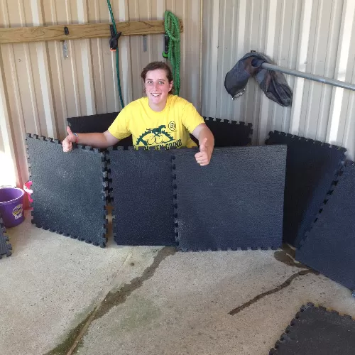 Portable Horse Stall Mats showing customer with the mats.