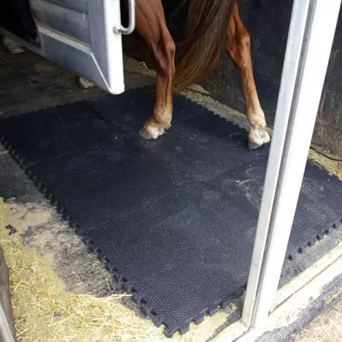 Portable Horse Stall Mats showing horse mat installation trailer