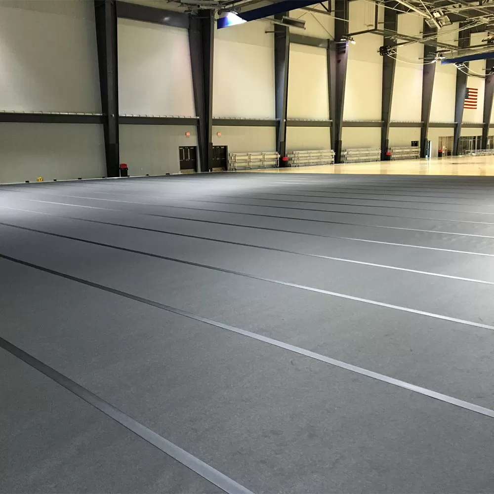 rolls of carpet covering a gym floor for a dance or event