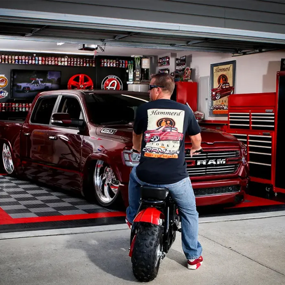 Motorcycle and Truck parked on RaceDeck CircleTrac Garage Floor Tiles 1/2 Inch x 1x1 Ft. in Alloy, Black, Graphite and Red