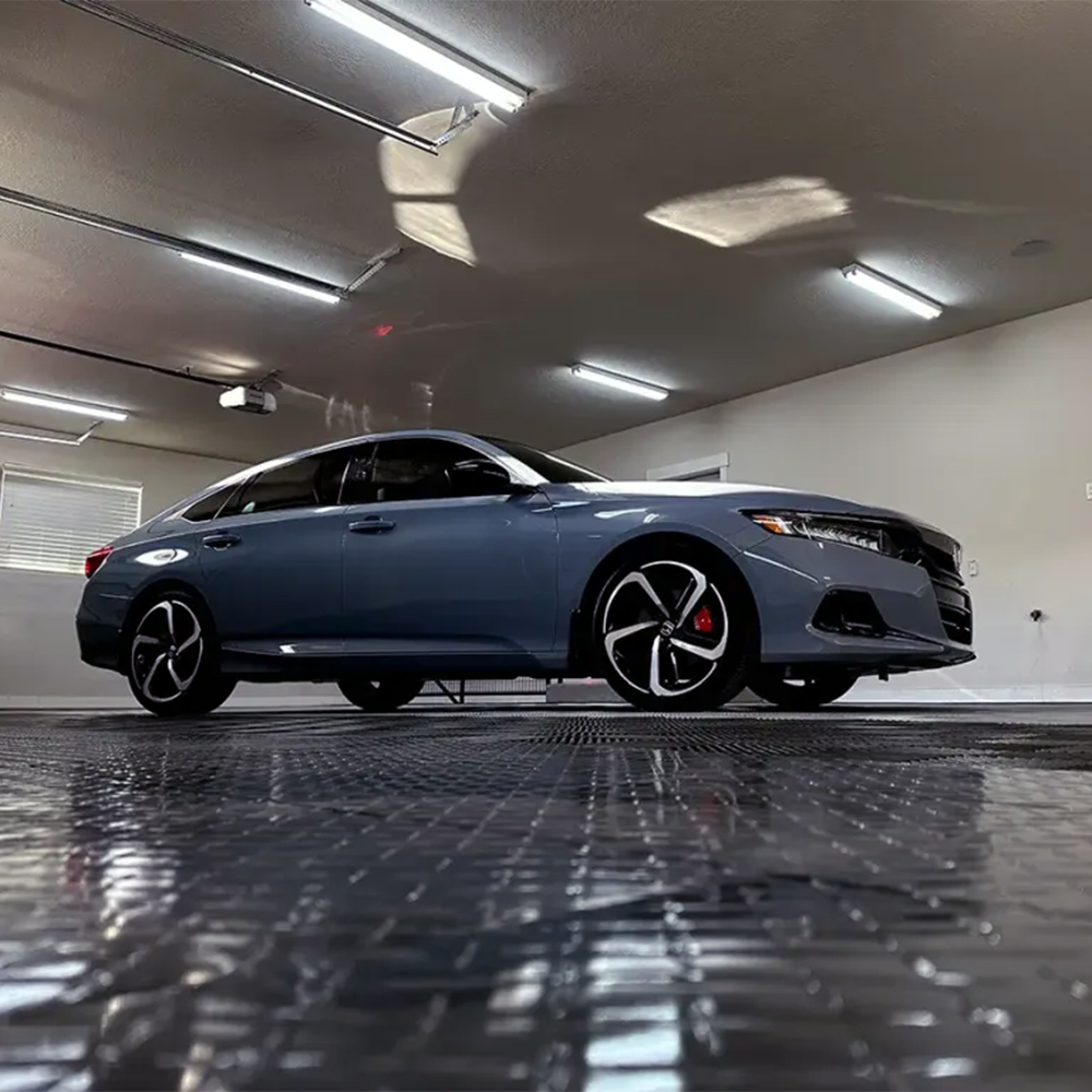 Car parked on RaceDeck Diamond TuffShield Garage Floor Tile 1/2 Inch x 1x1 Ft. in black and graphite