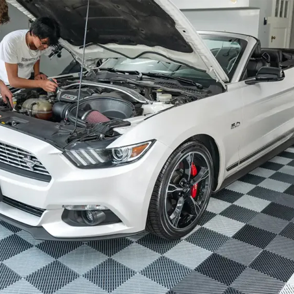 RaceDeck Free-Flow Garage Floor Tile 1/2 Inch x 1x1 Ft. in alloy, graphite, white and black working on car