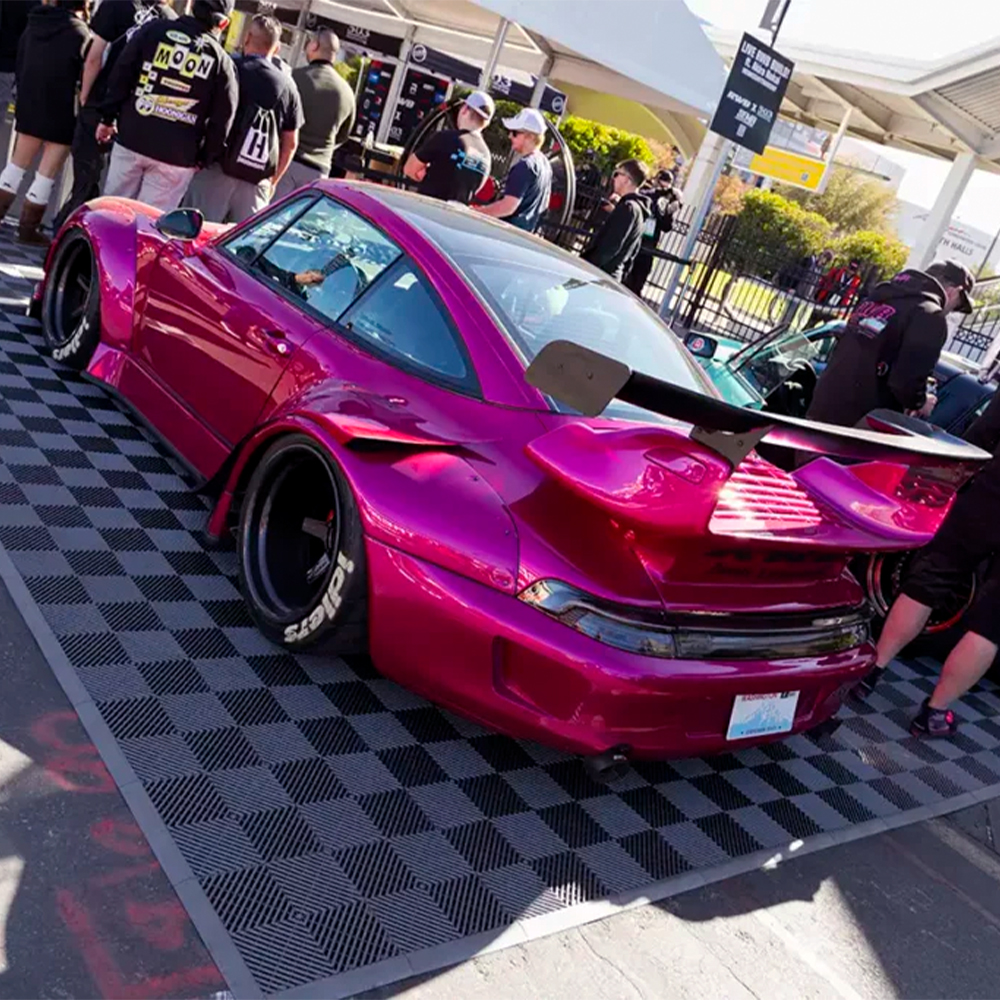 RaceDeck Free-Flow Garage Floor Tile 1/2 Inch x 1x1 Ft. show cars on black tiles