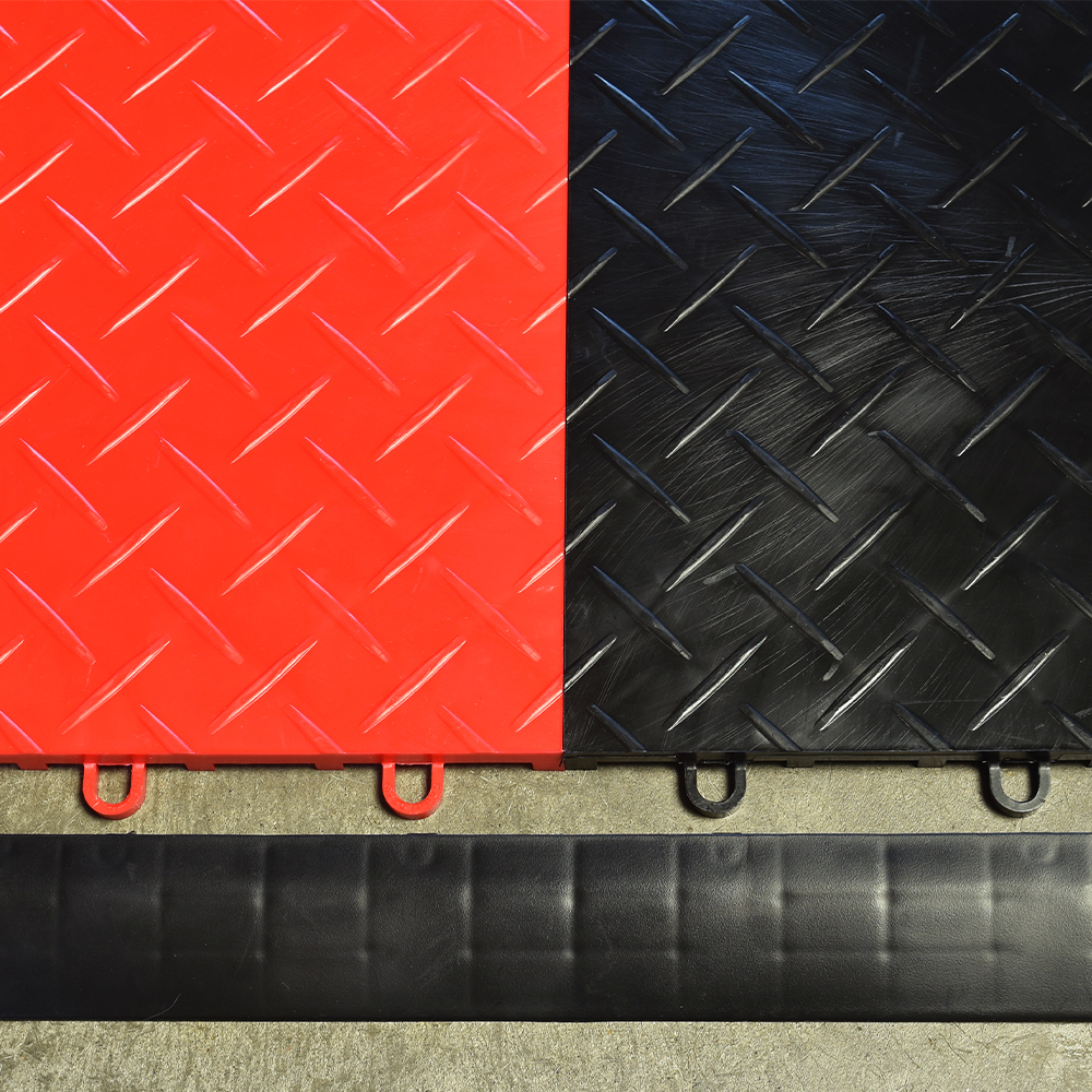 Close up of RaceDeck Garage Tile Border Corner Edges 1/2 Inch x 1.75x12 Inches in black with red and black Diamond Tuffshield
