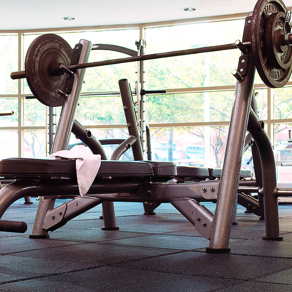 Action Sport Rubber Gym Tile 10% Color 1 Inch x 2x2 Ft. weight bench on blue tiles