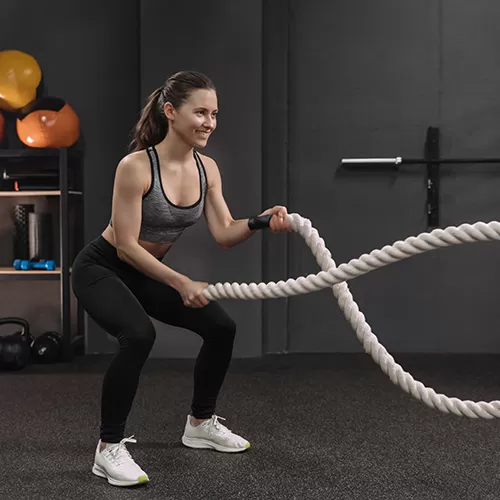 Rolled Rubber 20 percent color with woman using battle ropes